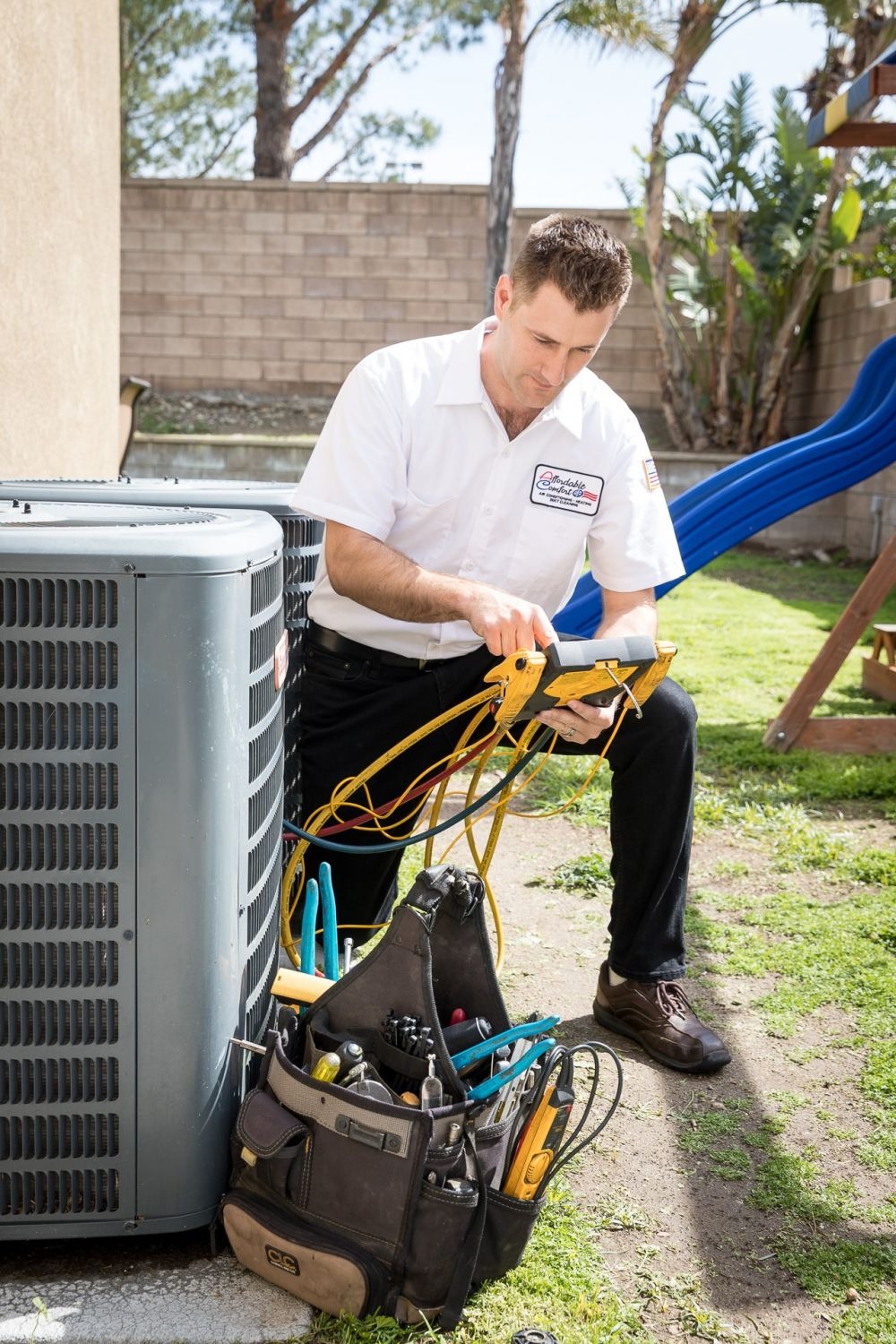 Man repairing outdoor air conditioning unit